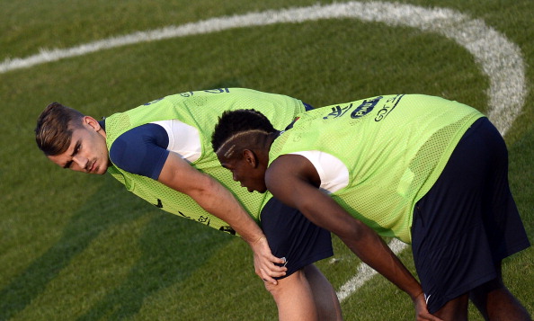 France's forward Antoine Griezmann (L) and midfielder Paul Pogba stretch during a training session at the Santa Cruz Stadium in Ribeirao Preto on June 11, 2014 ahead of the 2014 FIFA World Cup football tournament in Brazil. AFP PHOTO / FRANCK FIFE (Photo credit should read FRANCK FIFE/AFP/Getty Images)