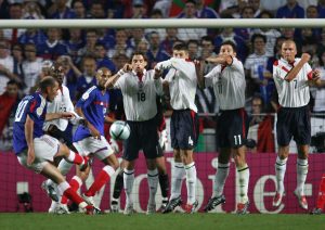 BEST OF ENGLAND FRANCE AT EURO 2004. French captain Zinedine Zidane (L) scores France's equaliser against England, 13 June 2004 during their opening match at the European Nations football championships at the Estadio da Luz in Lisbon. France and England are competing in Group B with Croatia and Switzerland. AFP PHOTO FRANCK FIFE (Photo credit should read FRANCK FIFE/AFP/Getty Images)